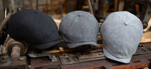 The Baker Boy is here in 3 color ways, Black, Herringbone and Grey. Shown sitting on a work bench.